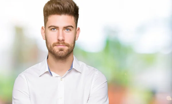 Young handsome business man Relaxed with serious expression on face. Simple and natural looking at the camera.