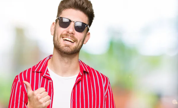 Genç Yakışıklı Adam Hareketi Ile Mutlu Yaşasın Yaparken Güneş Gözlüğü — Stok fotoğraf