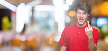Young handsome man wearing red t-shirt over isolated background Showing middle finger, impolite and rude fuck off expression