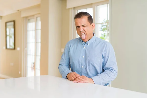 Hombre Mediana Edad Sentado Casa Sacando Lengua Feliz Con Expresión — Foto de Stock