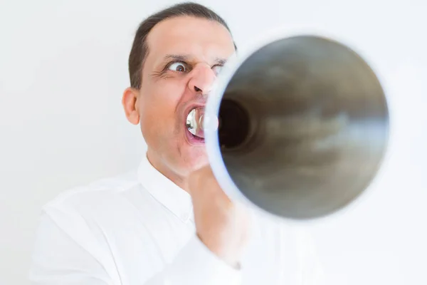 Middle age man shouting through a megaphone — Stock Photo, Image