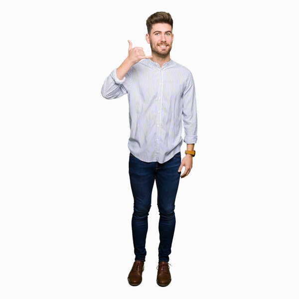 Young handsome man smiling doing phone gesture with hand and fingers like talking on the telephone. Communicating concepts.