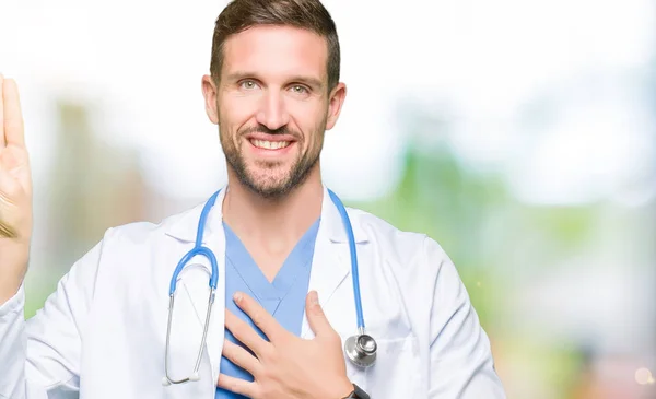 Handsome doctor man wearing medical uniform over isolated background Swearing with hand on chest and fingers, making a loyalty promise oath