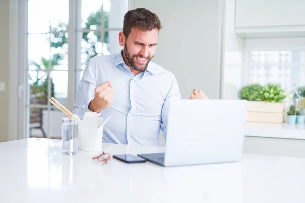 Uomo d'affari mangiare take away asiatico tagliatelle cibo mentre lavoro u — Foto Stock