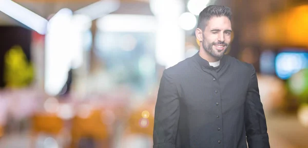 Joven Sacerdote Cristiano Sobre Fondo Aislado Guiño Mirando Cámara Con —  Fotos de Stock