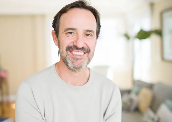 Handsome middle age man smiling looking at the camera at home — Stock Photo, Image