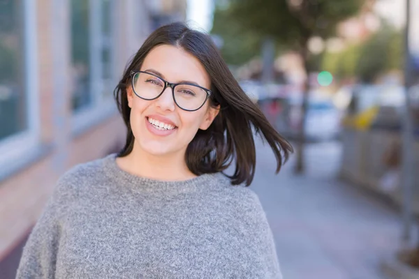 Young beautiful woman wearing glasses smiling confident walking