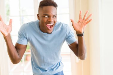 Afrika kökenli Amerikalı adam çok heyecanlı ve kutluyor başarı ve zafer, çığlık happpy gülümseyerek ve neşeli