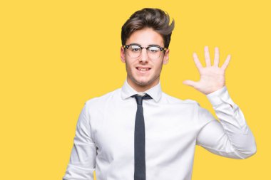 Gösterilen arka plan üzerinde gözlük takan genç iş adamı izole ve parmakları ile işaret kendinden emin ve mutlu gülümseyerek süre beş numara.