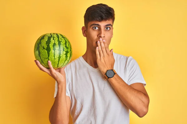 Young Indian Shopkeeper Man Holding Watermelon Standing Isolated Yellow Background — Stock Photo, Image