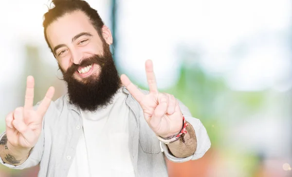 Young Man Long Hair Beard Earrings Smiling Looking Camera Showing — Stock Photo, Image