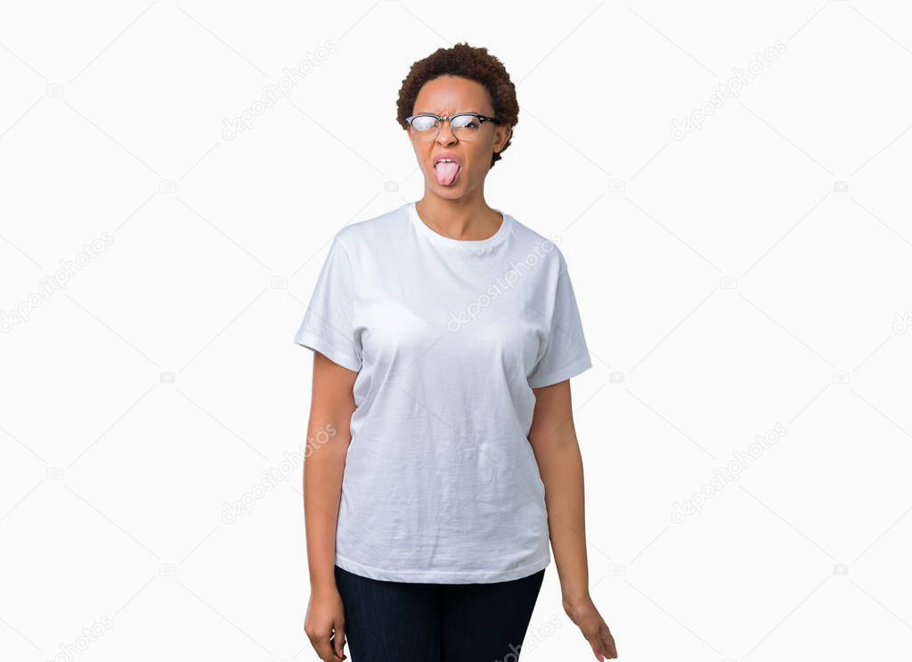 Beautiful young african american woman wearing glasses over isolated background sticking tongue out happy with funny expression. Emotion concept.