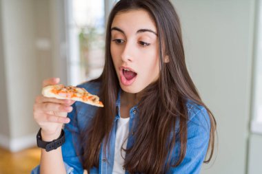 Lezzetli pizza bir dilim yemek güzel genç kadın sürpriz bir yüz ile şok korkuyor ve korku ifadesi ile heyecanlı korkmuş