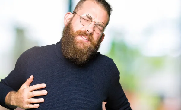 Young Blond Man Wearing Glasses Turtleneck Sweater Stretching Back Tired — Stock Photo, Image