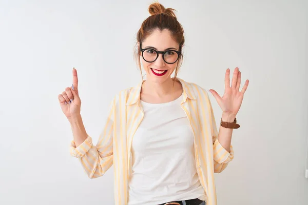 Redhead woman wearing striped shirt and glasses standing over isolated white background showing and pointing up with fingers number six while smiling confident and happy.