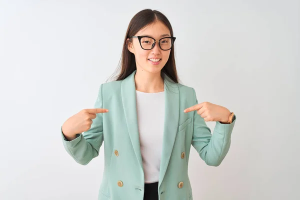 Chinese businesswoman wearing elegant jacket and glasses over isolated white background looking confident with smile on face, pointing oneself with fingers proud and happy.