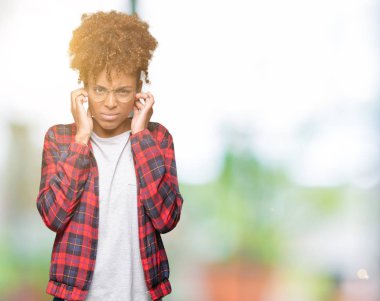 Yüksek sesle müzik gürültü rahatsız ifade parmaklarıyla kulaklarıyla kapsayan izole arka plan üzerinde gözlük güzel genç Afro-Amerikan kadın. Sağır kavramı.