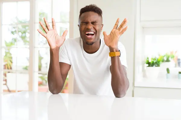 Handsome African American Man White Table Home Celebrating Mad Crazy — Stock Photo, Image
