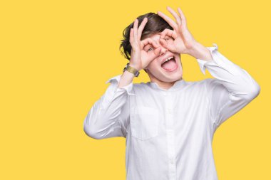 Genç yakışıklı iş adamı, dilini parmaklarının arasından baktığını yapışmasını dürbün gibi ok jest yapıyor izole arka plan üzerinde. Deli ifade.