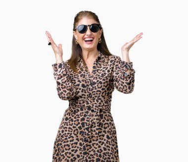 Arka plan deli kutluyor üzerinde güneş gözlüğü ve leopar elbise giyen orta yaş olgun zengin kadın izole ve crazy arms ile başarı için kaldırdı ve heyecanlı çığlık gözler kapalı. Kazanan kavramı