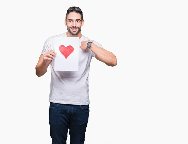 Guapo Joven Sosteniendo Tarjeta Con Corazón Rojo Sobre Fondo Aislado — Foto de Stock