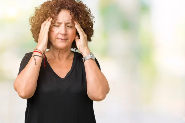 Beautiful middle ager senior woman over isolated background with hand on head for pain in head because stress. Suffering migraine.