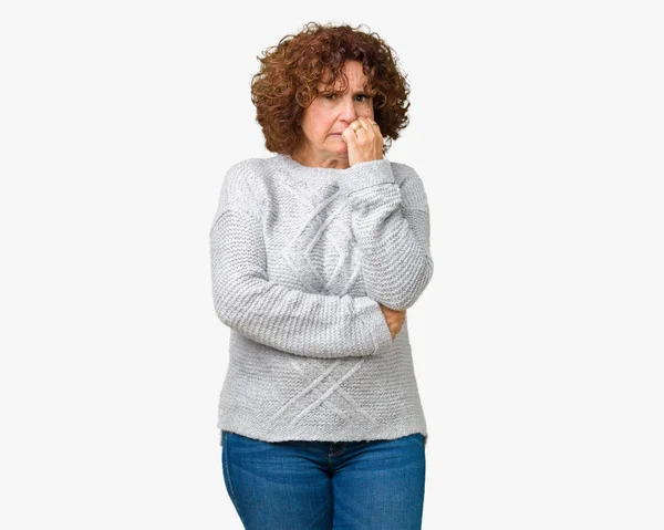 美しい中間エイガー不安や両手の爪を噛んで口の中で緊張を探して孤立の背景に冬のセーターを着ている年配の女性 不安の問題 — ストック写真