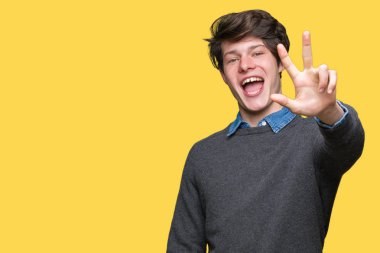 Genç yakışıklı zarif adam gösterilen ve parmakları ile işaret izole arka plan üzerinde üçüncü ise kendinden emin ve mutlu gülümseyerek.