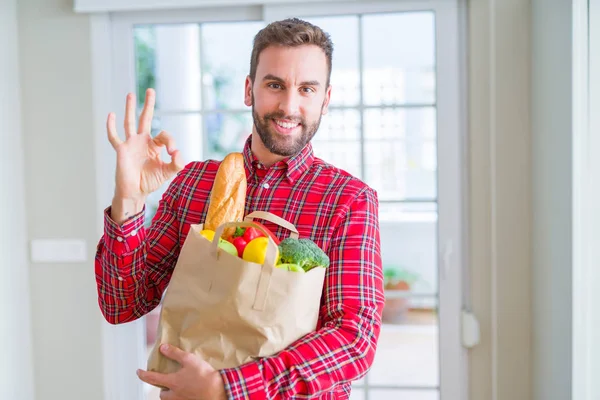 Handsome Man Holding Groceries Bag Doing Sign Fingers Excellent Symbol — Stock Photo, Image