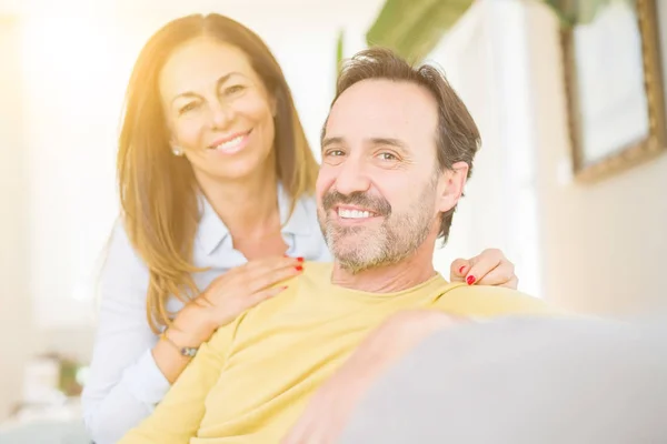 Middle age romantic couple sitting on the sofa at home — Stock Photo, Image
