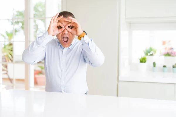 Middle Age Man Sitting Home Doing Gesture Binoculars Sticking Tongue — Stock Photo, Image
