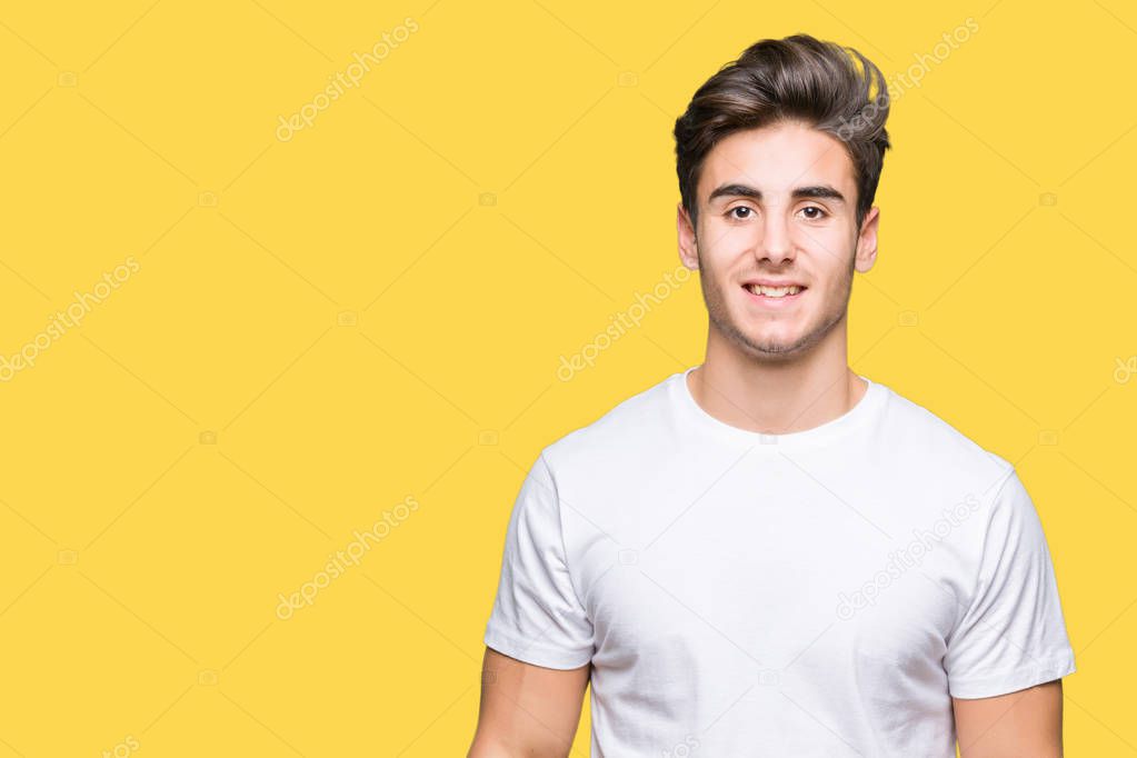 Young handsome man wearing white t-shirt over isolated background with a happy and cool smile on face. Lucky person.