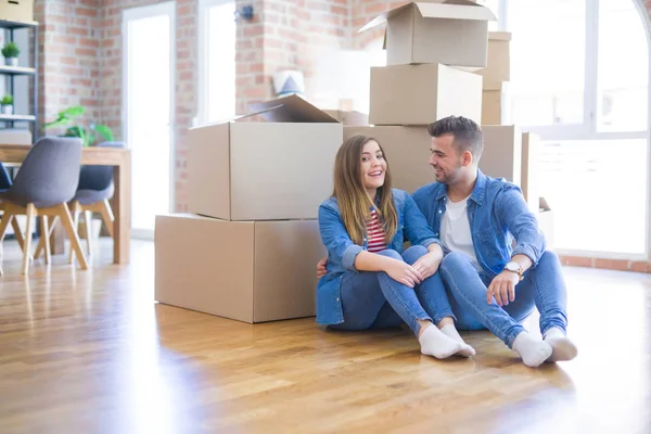 Pasangan muda yang cantik jatuh cinta pindah ke rumah baru, duduk di th — Stok Foto