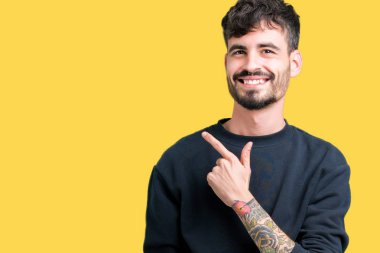 Yakışıklı delikanlı izole arka neşeli bir gülümseme ile el ve parmak kadar yan yüzünde mutlu ve doğal ifade ile işaret yüz üzerinden