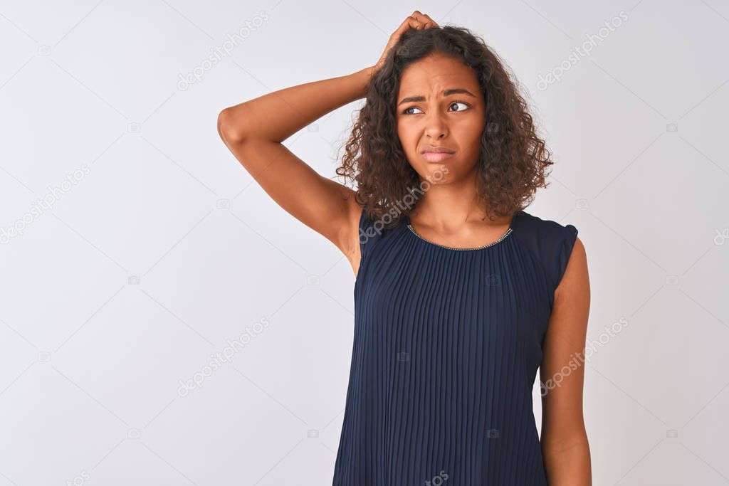 Young brazilian woman wearing blue dress standing over isolated white background confuse and wonder about question. Uncertain with doubt, thinking with hand on head. Pensive concept.