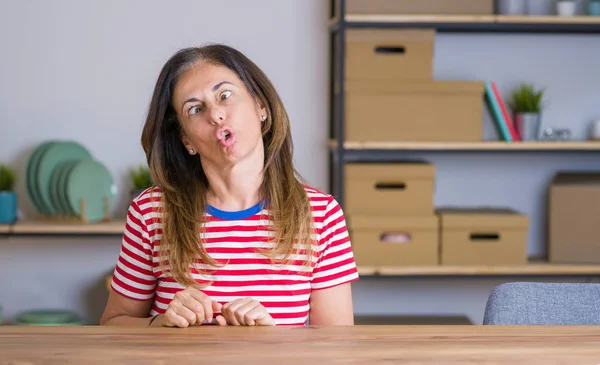 Middle Age Senior Woman Sitting Table Home Making Fish Face — Stock Photo, Image