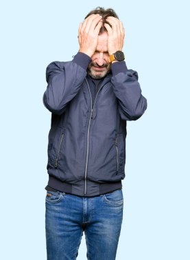 Çünkü umutsuz ve stresli baş ağrısı acı bir ceket giyen orta yaş yakışıklı adam ağrı ve migren. Ellerini kafasına.