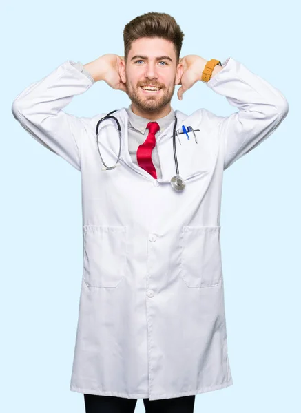 Young Handsome Doctor Man Wearing Medical Coat Relaxing Stretching Arms — Stock Photo, Image