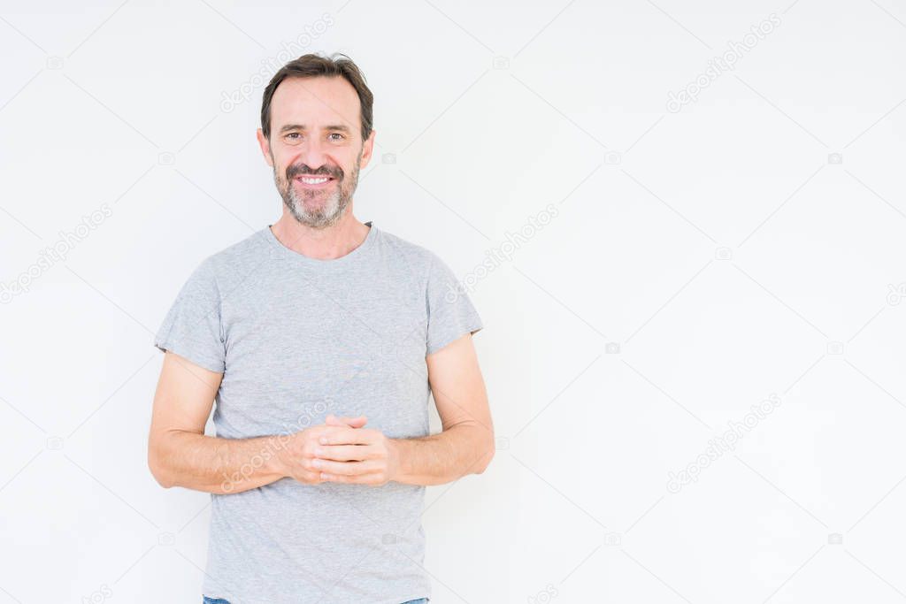 Handsome senior man over isolated background Hands together and fingers crossed smiling relaxed and cheerful. Success and optimistic
