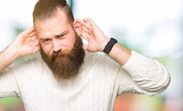Joven Hombre Hipster Con Suéter Invierno Tratando Escuchar Ambas Manos —  Fotos de Stock