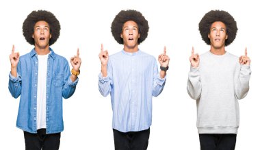 Beyaz izole arka plan üzerinde afro saç ile genç adam kolaj hayret ve görünümlü ve parmaklar ve yükseltilmiş kollar ile işaret şaşırdı.