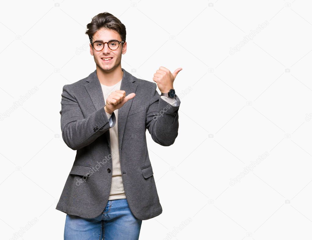 Young business man wearing glasses over isolated background Pointing to the back behind with hand and thumbs up, smiling confident