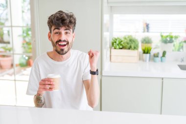 Genç adam sabah bir kağıt fincan bir kahve içme gurur çığlık ve zafer ve başarı kutluyor çok heyecanlı, duygu tezahürat