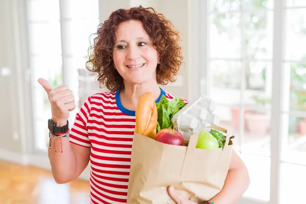 Senior Woman Holding Paper Bag Full Fresh Groceries Supermarket Pointing — Stock Photo, Image