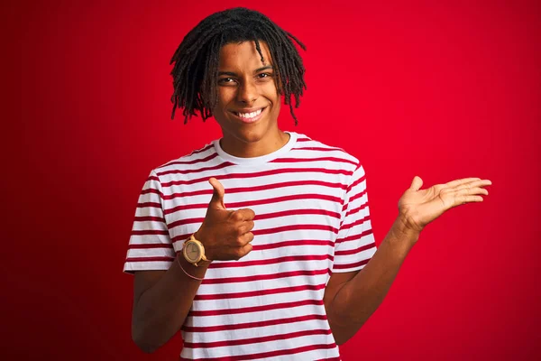 Young Afro Man Dreadlocks Wearing Striped Shirt Standing Isolated Red — Stock Photo, Image