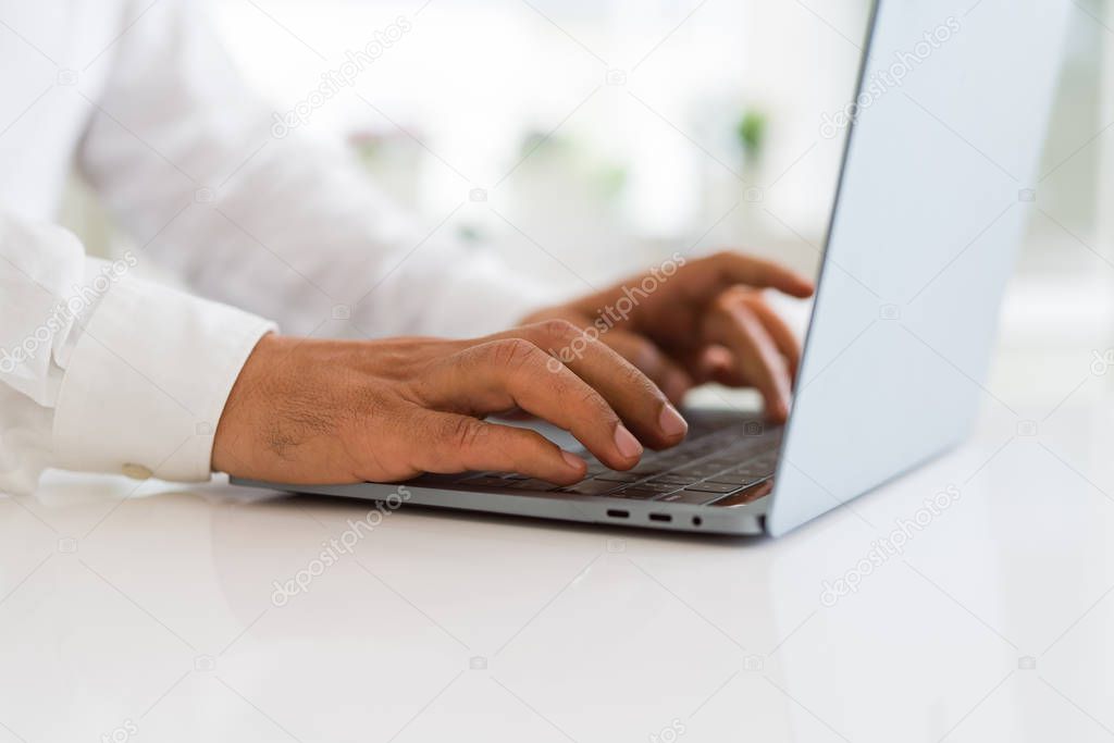Close up of business man working using computer laptop