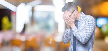 Üzgün ifade yüz eller ile ağlayarak süre kapsayan ile izole arka plan üzerinde gözlük takan genç iş adamı. Depresyon kavramı.
