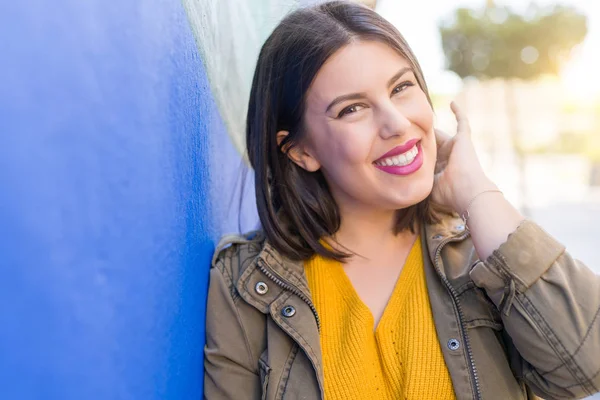 Beautiful young woman smiling confident and cheerful leaning on