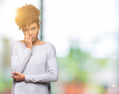 Güzel genç Afro-Amerikan kadın yüzünden stresli ve gergin ile izole arka plan tırnak ısırma dudaklarından eller. Anksiyete sorunu.