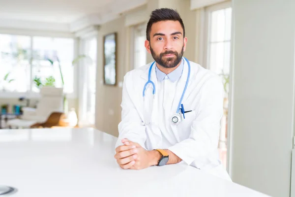 Handsome Hispanic Doctor Man Wearing Stethoscope Clinic Serious Expression Face — Stock Photo, Image